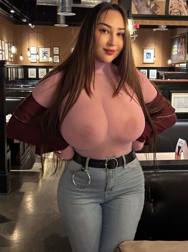 Louisa pink see-through top standing at bar