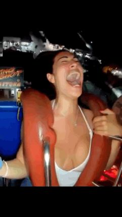 Sexy brunette has her titties nearly pop out on a roller coaster