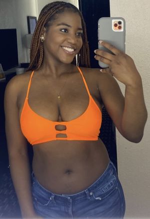 Sexy black chick in bikini top with huge breastesies