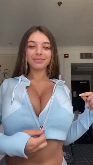 Unzipping reveal of big boobs.