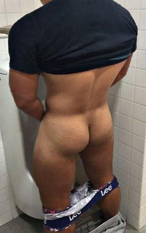 Showing his nice ass in the men's room