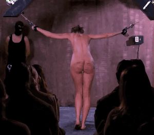 suspended slave has his ass whipped in front of an audience
