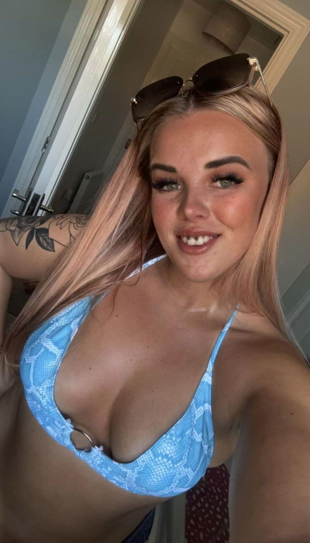 Stunning redhead showing off her only useful assets