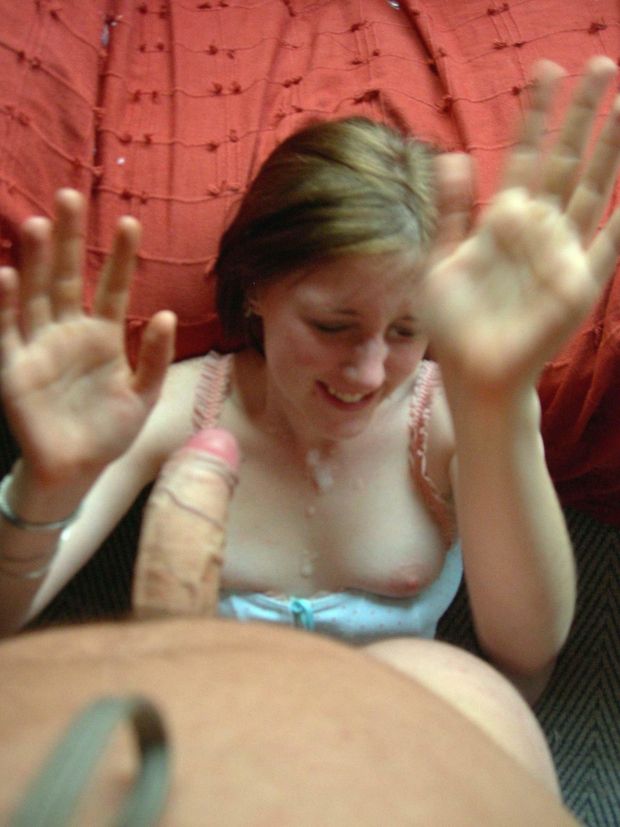 Amateur brunette throwing her hands up while getting facialized by an uncut cock
