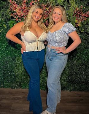 Kate & friend in front of hedge