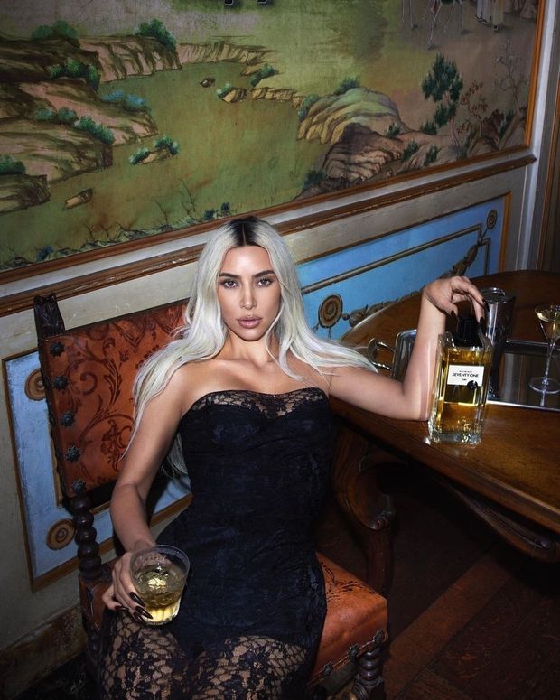 Blonde alone with a drink.