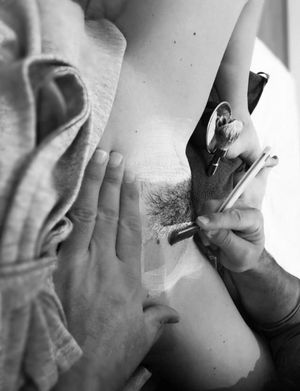 Shaving a landing strip for her hot date tonight.