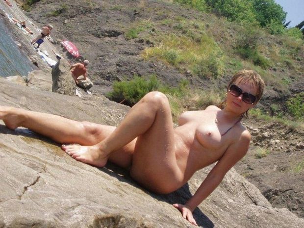 Nudist woman at the beach