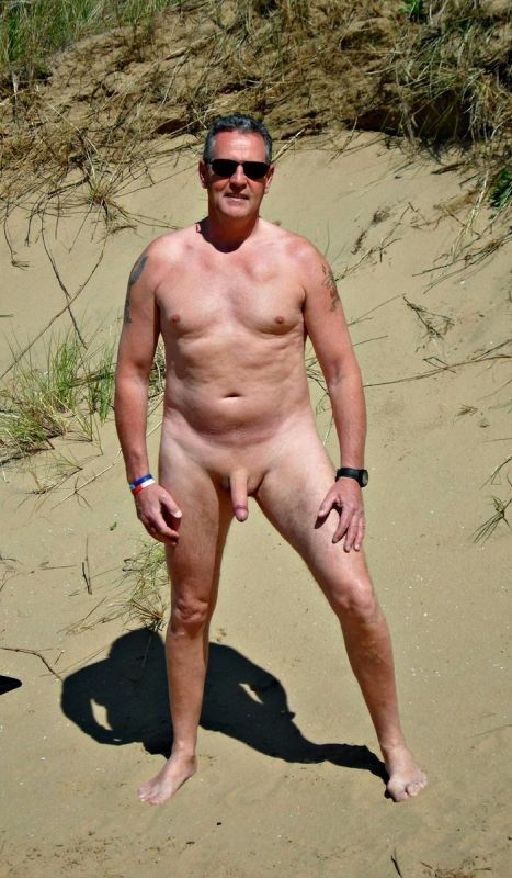 A mature naked man in the desert