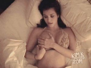 Kim frees her nipples but doesn't remove her bra.