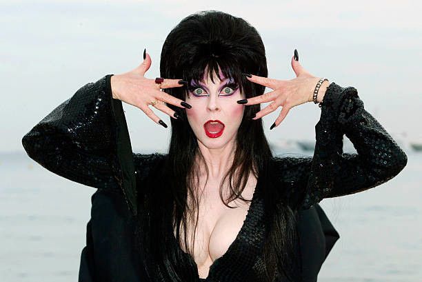 Elvira watches you about to spread your semen all over her