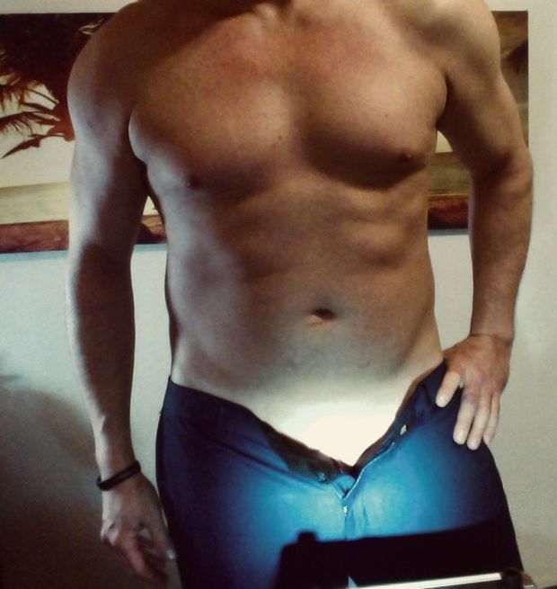 Athletic guy stripping  down