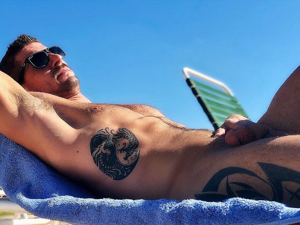Man tattoed on beach