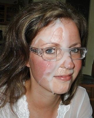 Bespectacled wife has a huge blob of jizz on her face