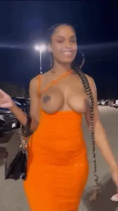 Sexy black babe shows off her tits in the parking lot