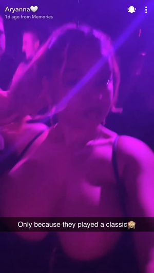 Busty ebony showing off tits at club
