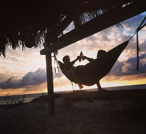 Having beers at sunset in a hammock on the beach.