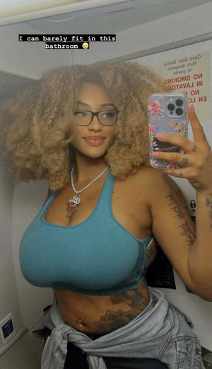 Sophia Ifeoma taking selfies in an airplane lavatory