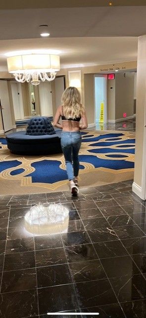 Sexy Blond in Hotel Hallway Stripping