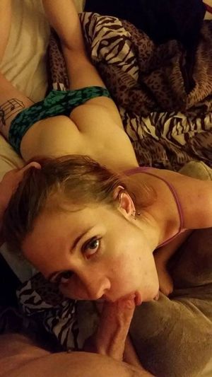 Brunette amateur lying down with an average-sized dick in her mouth