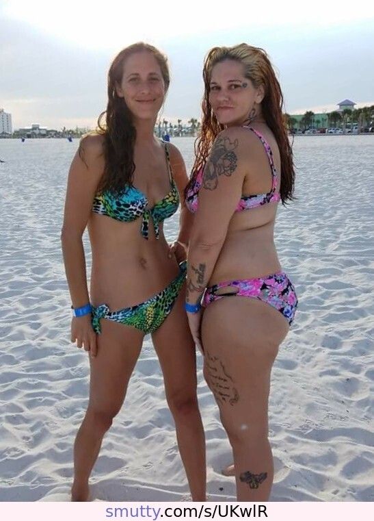 Two slutty lil MILF's pose for the camera beachside