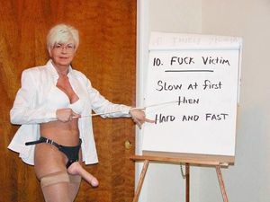 Sandy Ward instructing others how to use a strapon.