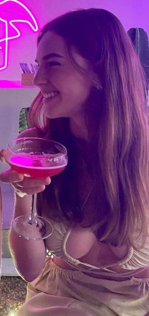 Emily cleavage in dress with drink