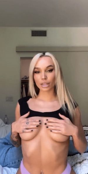 Slim blonde plays with tits