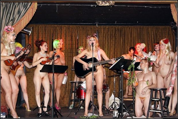 Nude band performing on stage.