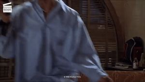 Kenya Moore unbuttoning her shirt in front of Marlon Wayans in “Senseless”