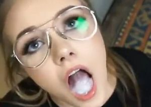 Sexy babe with a mouth filled with cum