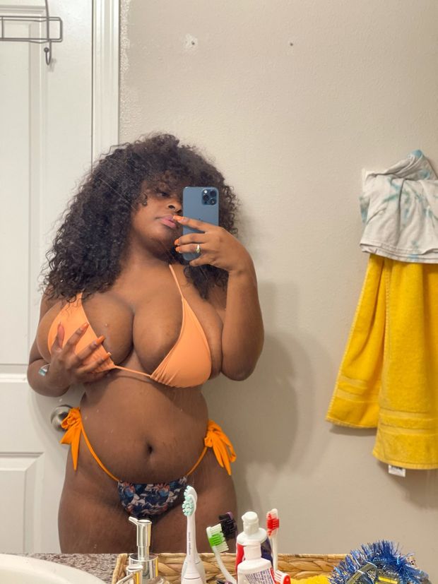 Dezodbaby grabbing her breast while in a bikini