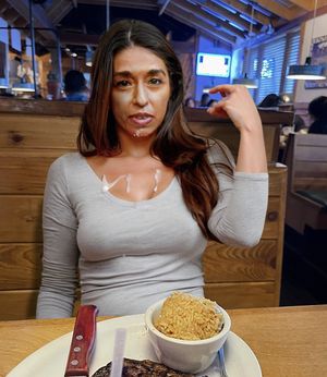 Traci eating in restaurant with cum on her face