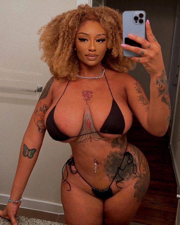 Sophia Ifeoma taking selfies in a Black bikini