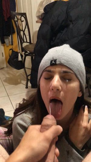 Action-shot of a facial from an uncut dick on the face of an amateur brunette