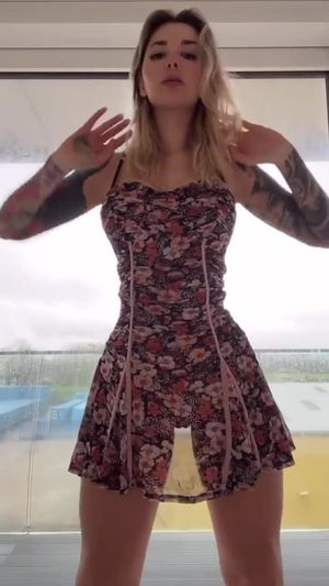 Hottie in a dress doing a little dance