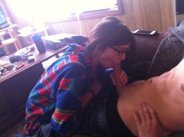 Brunette amateur with glasses sucking on a dick