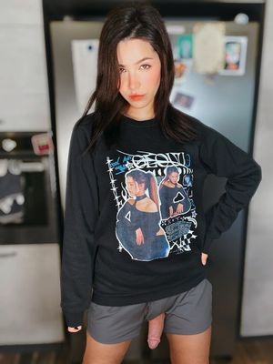 Beautiful ASMR Glow nude shows off her merch while her dick pokes out her shorts